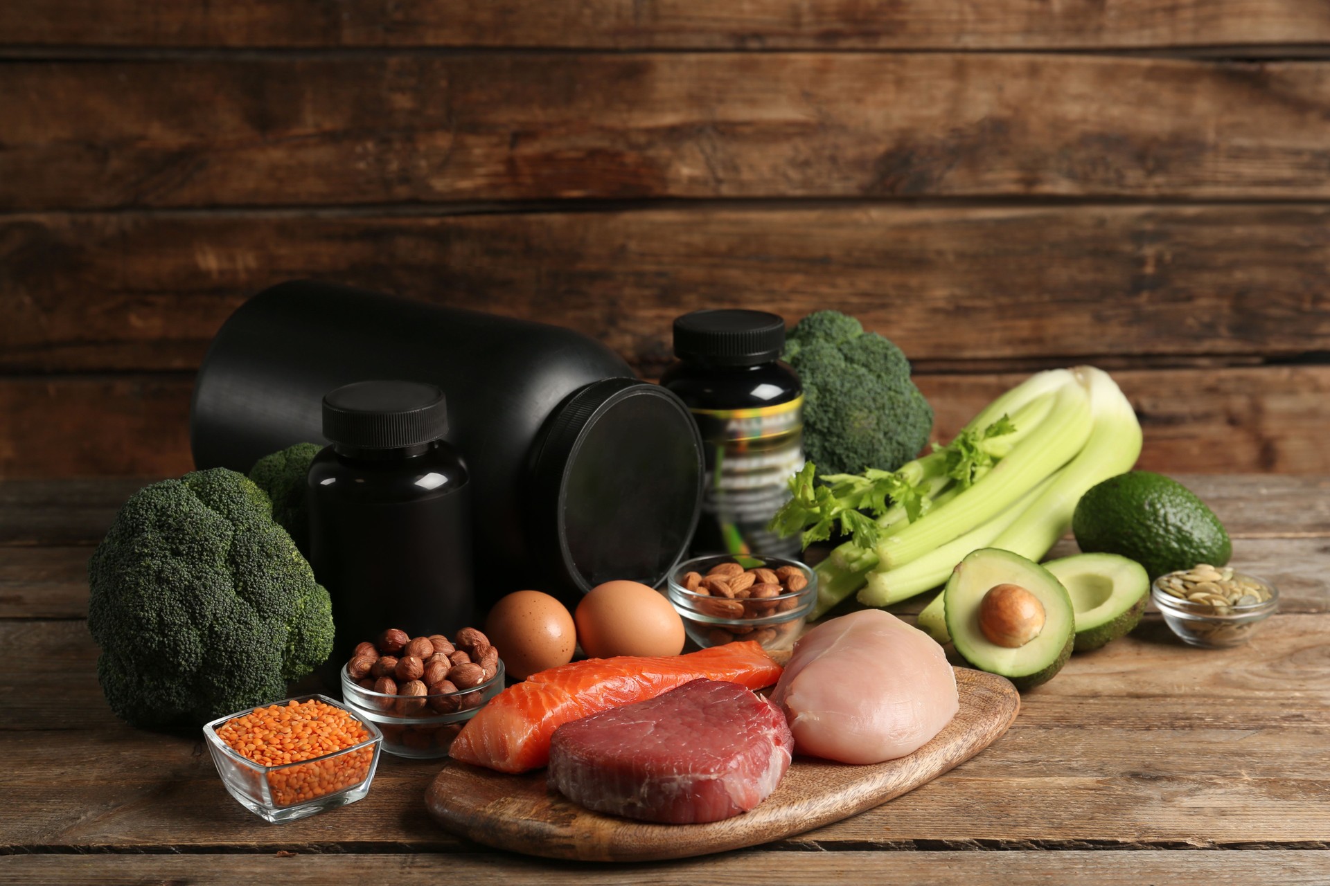 Set of products rich in amino acids and supplements on wooden table